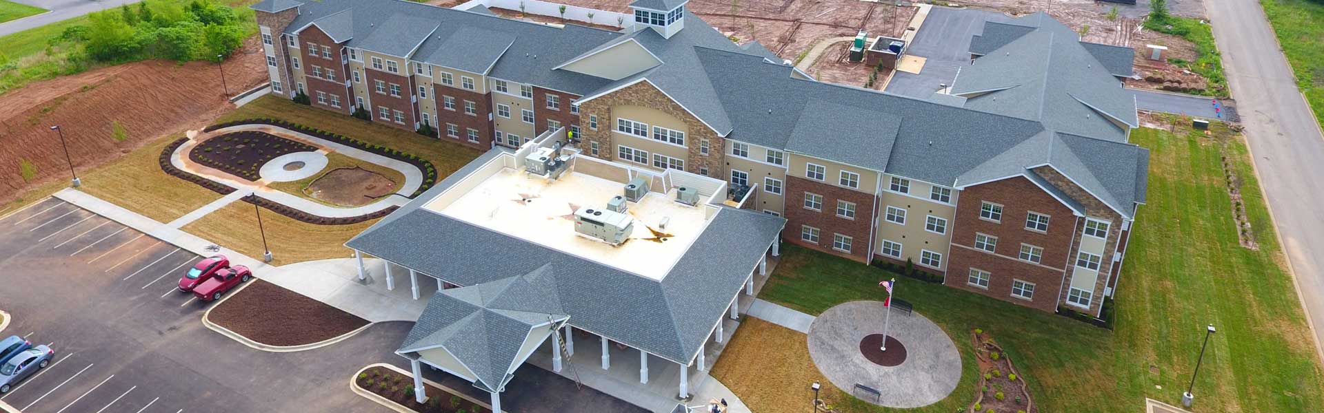 Large hotel with new gray shingles on its roof